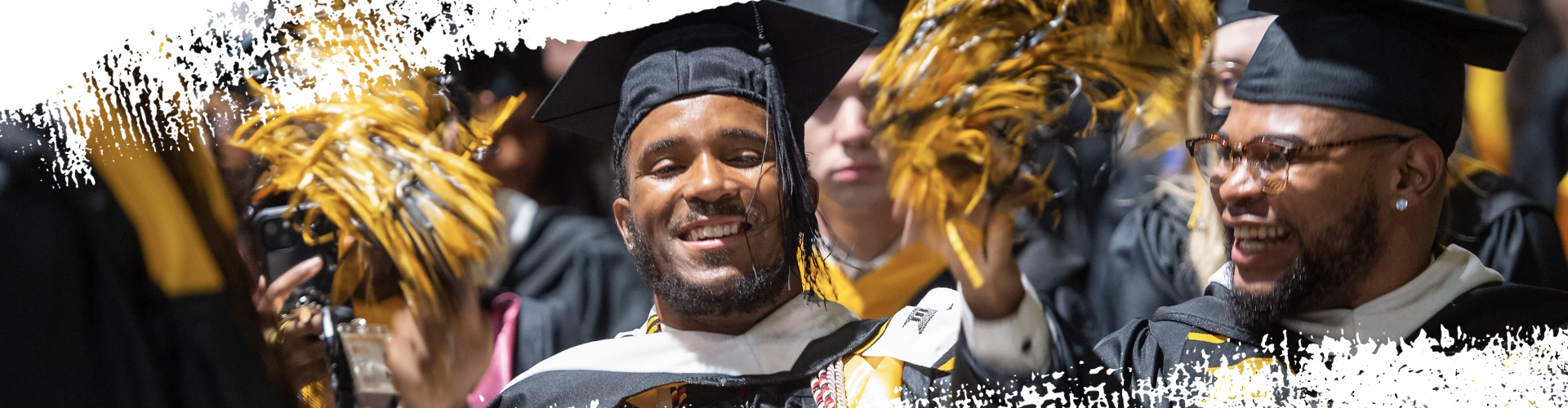two students walking in front of Cabell Library